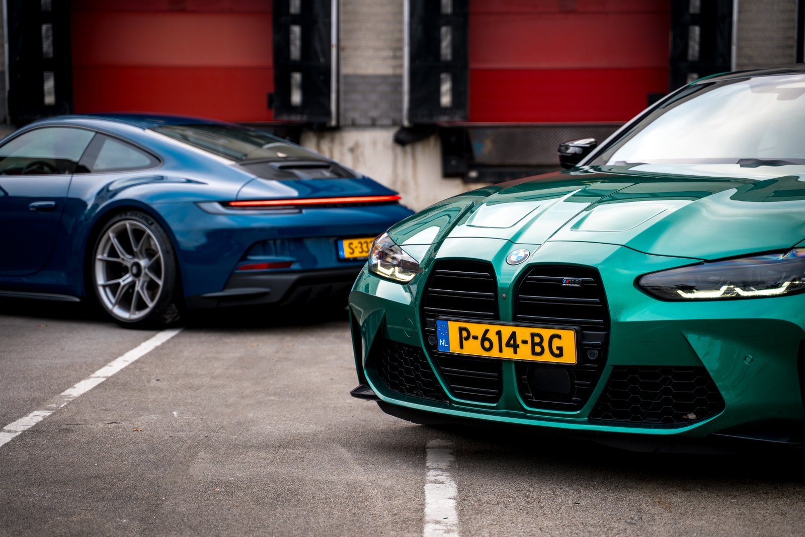 Front of BMW M4 and rear shot of Porsche GT3 Touring