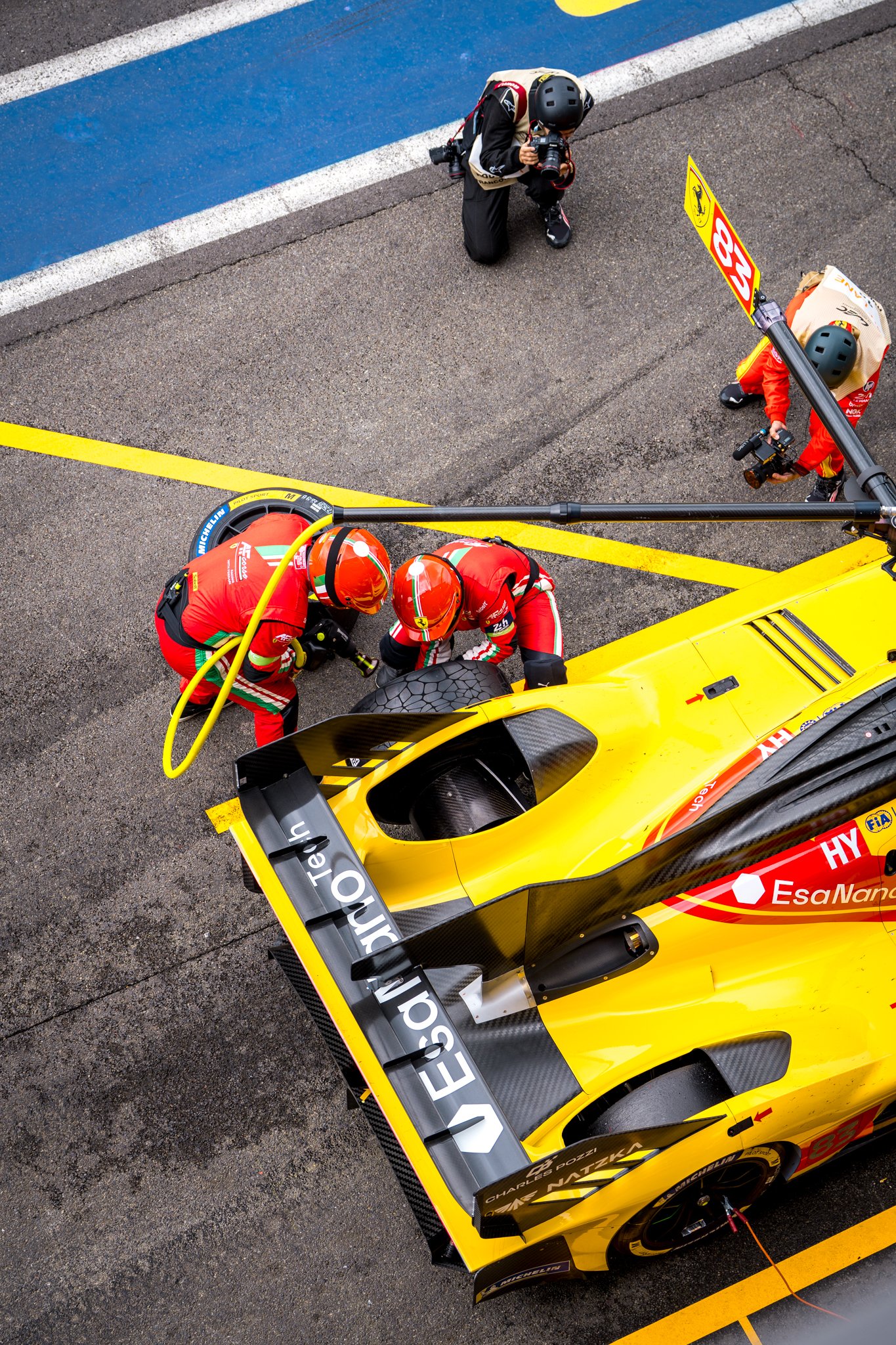 2 men changing tyres on the Ferrari hypercar