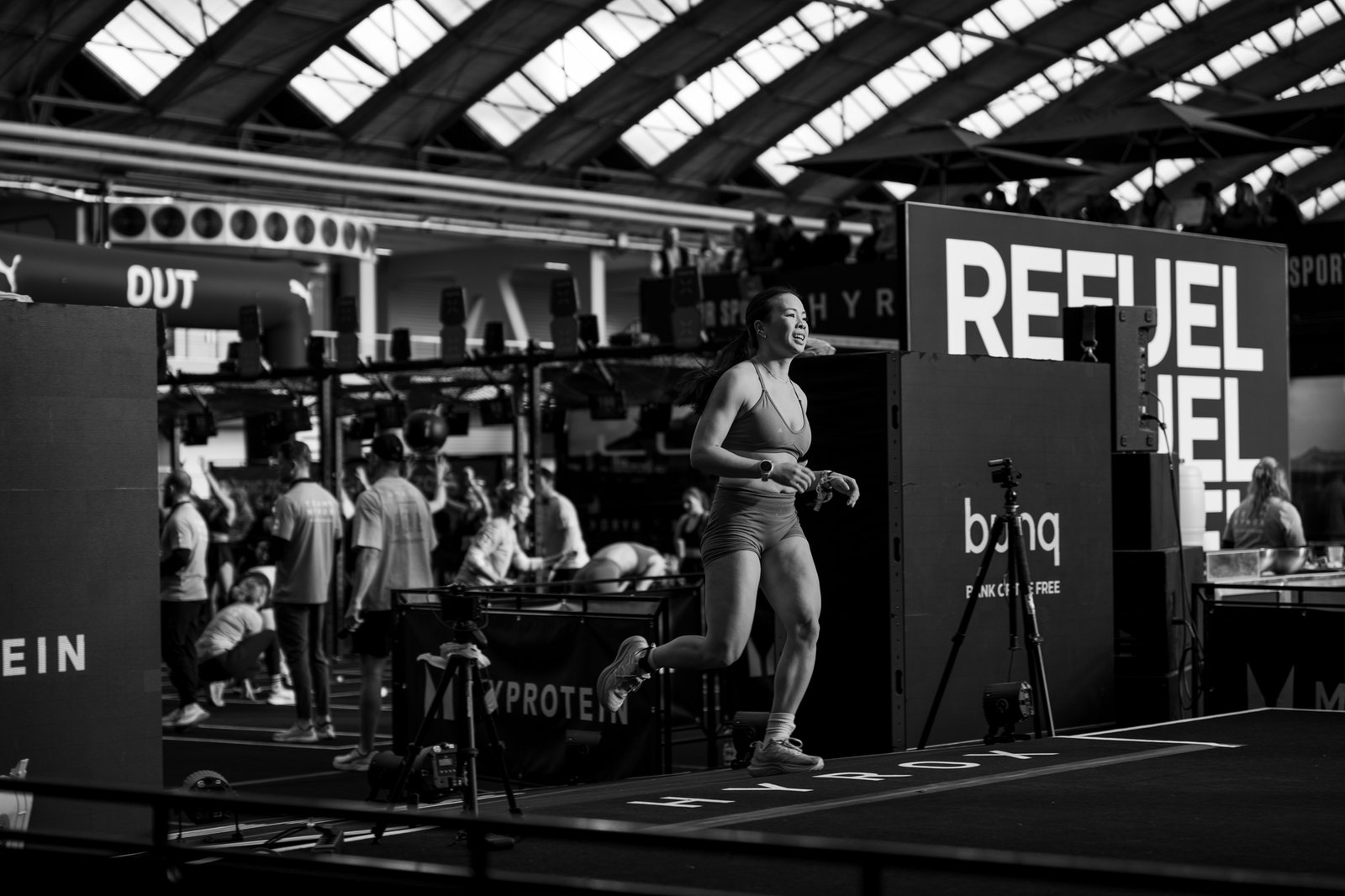 Black and white photo of woman finishing Hyrox event