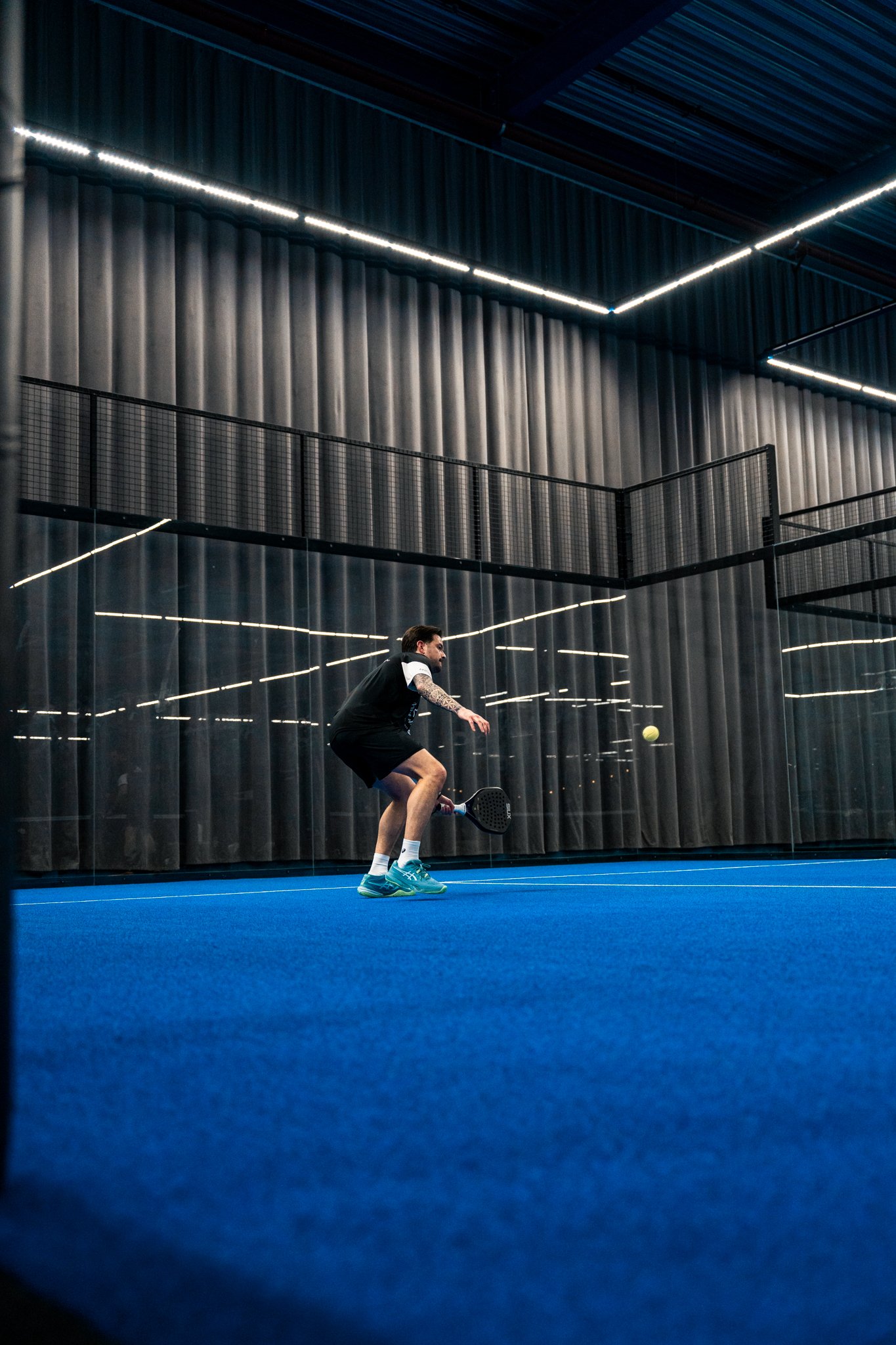 Low angle shot of a return during a padel match