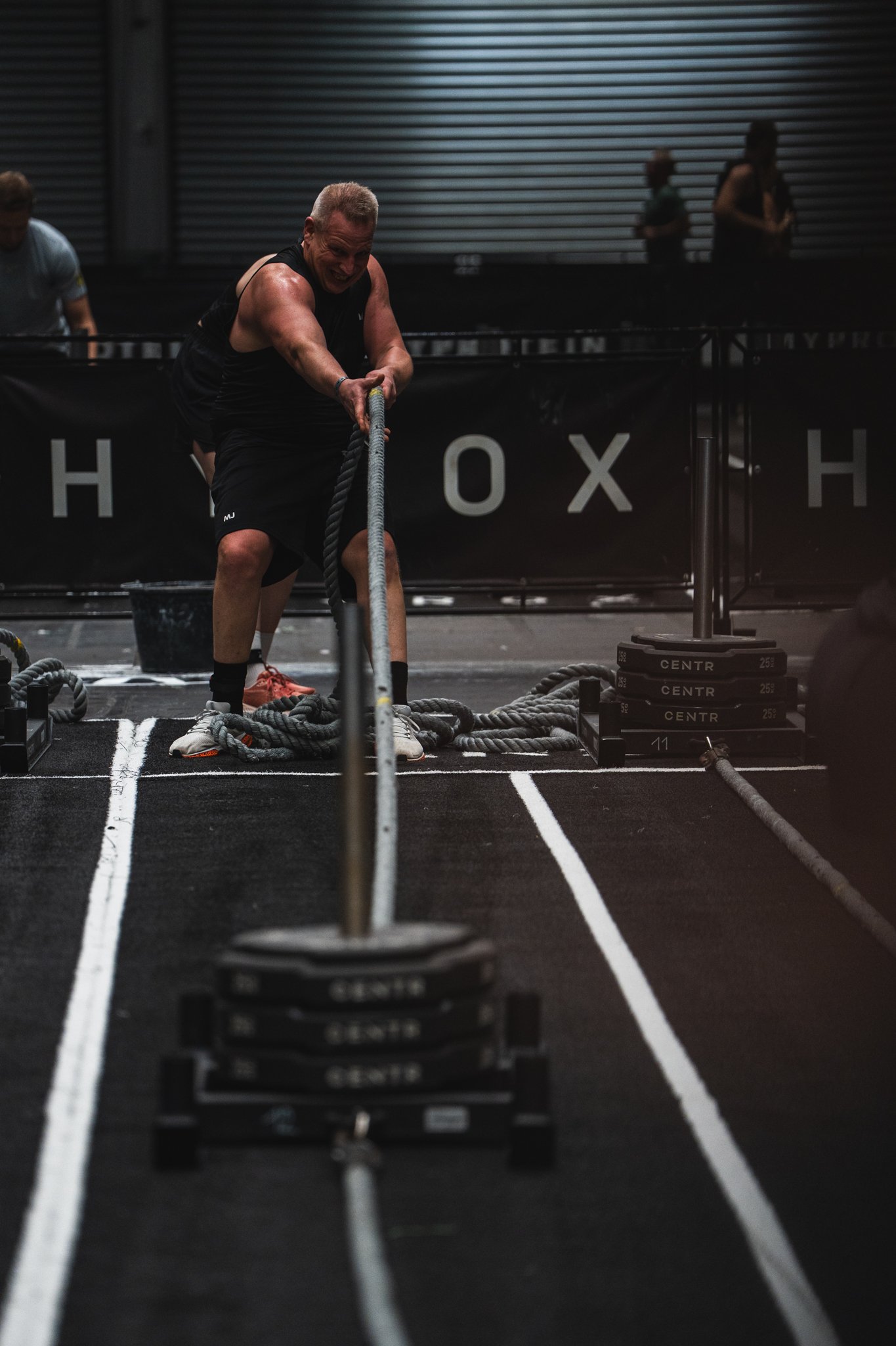 Man pulling sled during Hyrox event